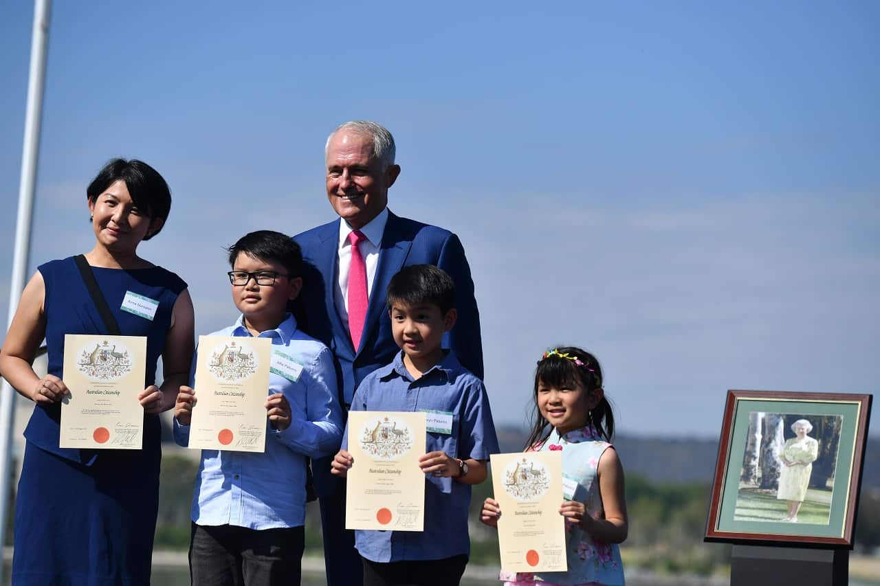Prime Minister Malcolm Turnbull poses with new Australian citizens at an Australia Day Citizenship Ceremony and Flag Raising event in Canberra.