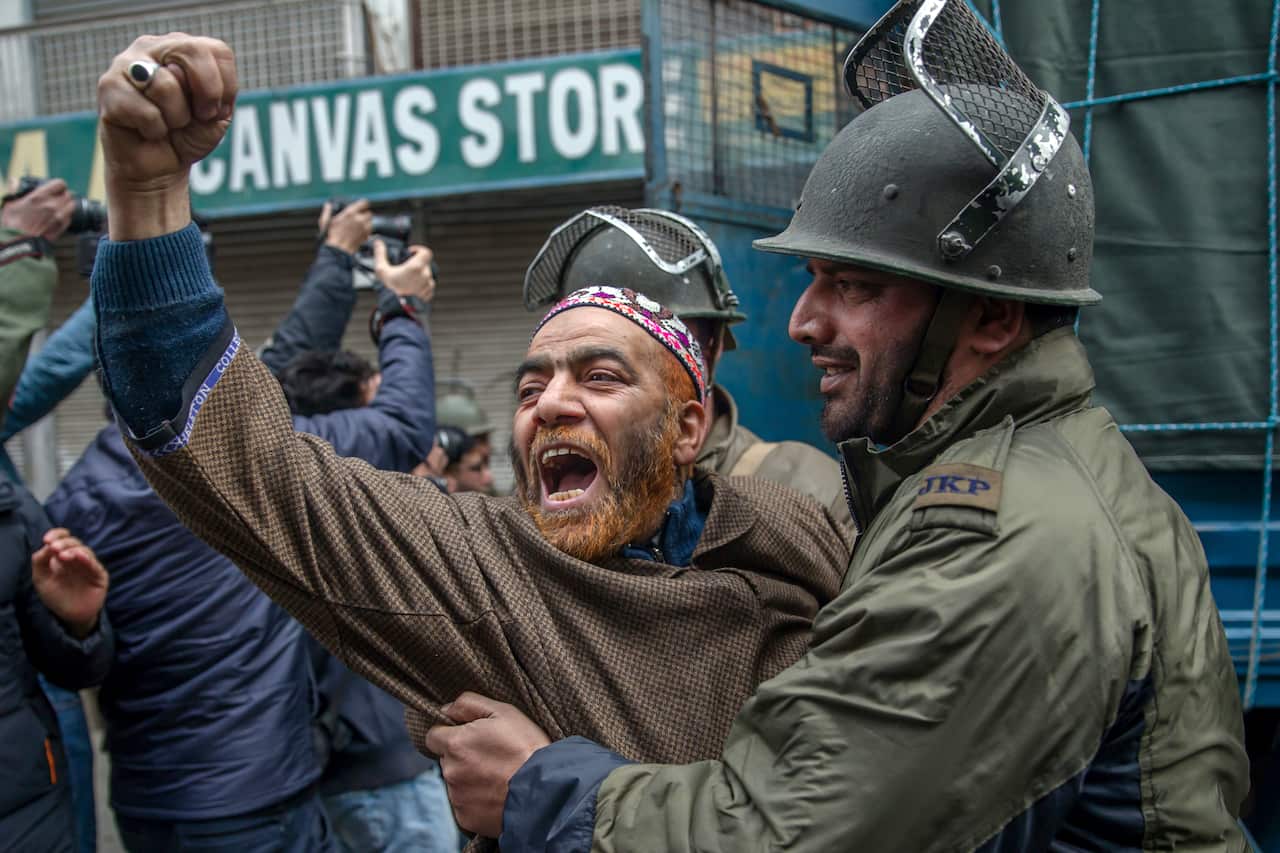 A supporter of All Parties Hurriyat Conference shouts pro-freedom slogans as Indian police officer detains his during a protest on the death anniversary of separatist leader Maqbool Bhat in Srinagar, Indian controlled Kashmir, 2018. 