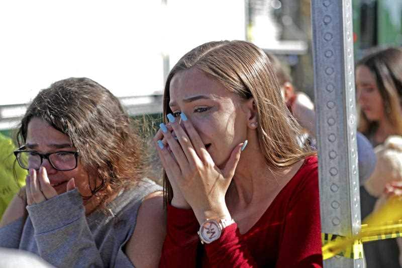 Students released from a lockdown are overcome with emotion following following a shooting at Marjory Stoneman Douglas High School in Parkland.
