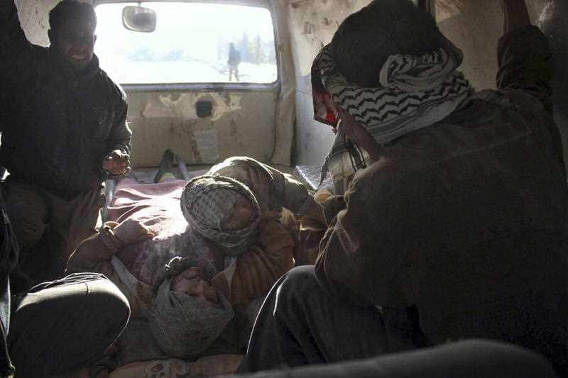 Injured people inside a Civil Defense van after airstrikes hit near Ghouta, a rebel-held suburb near Damascus, Syria.