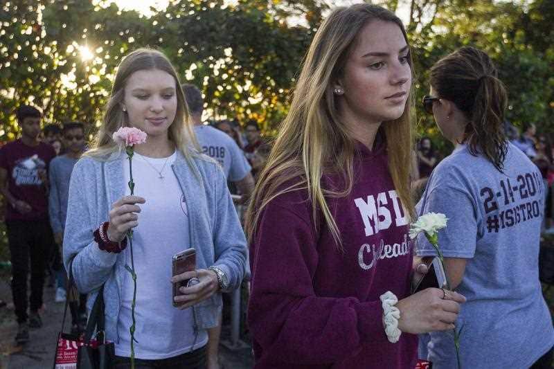 Students were greeted by supporters, signs and flowers as they returned to class at Marjory Stoneman Douglas High School.