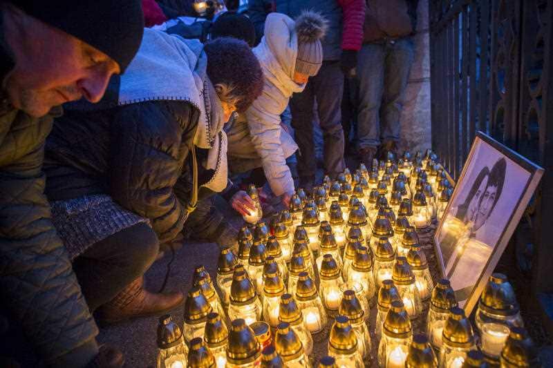 People place light tributes during a silent protest in memory of murdered journalist Jan Kuciak and his girlfriend Martina Kusnirova in Bratislava.