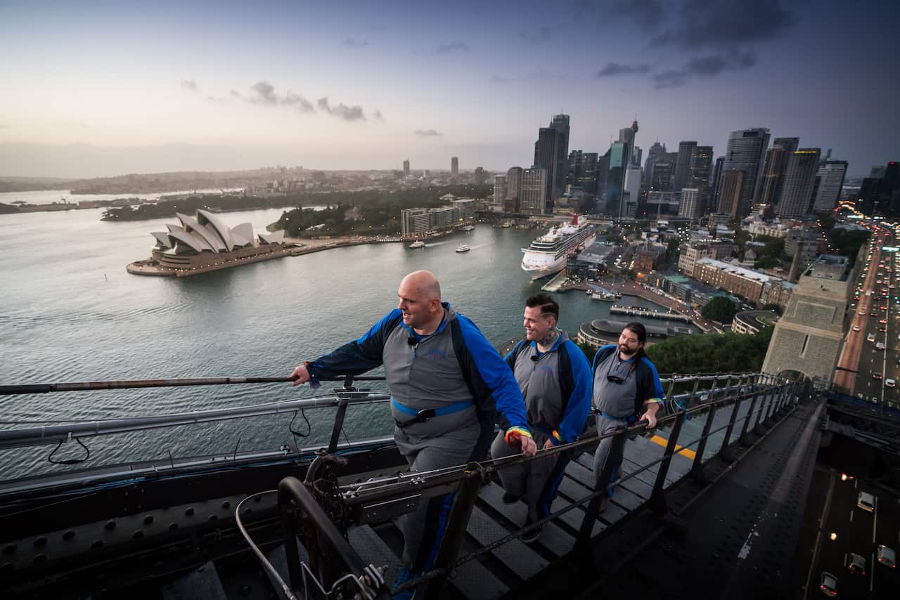 Paul Phillips and Warren Orlandi climb the Sydney Harbour Bridge.