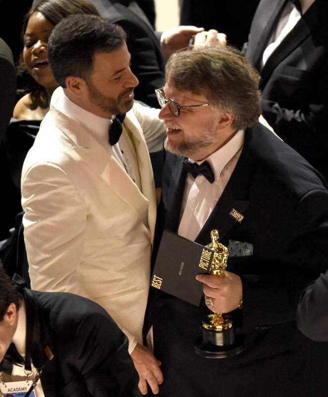 Guillermo del Toro, right, winner of the award for best picture for "The Shape of Water" celebrates with host, Jimmy Kimmel at the Oscars.
