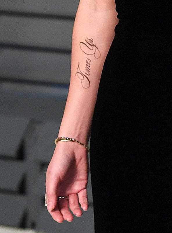 A tattoo supporting the 'Time's Up' campaign on the arm of Emma Watson as she arrives at the Vanity Fair Oscar Party.