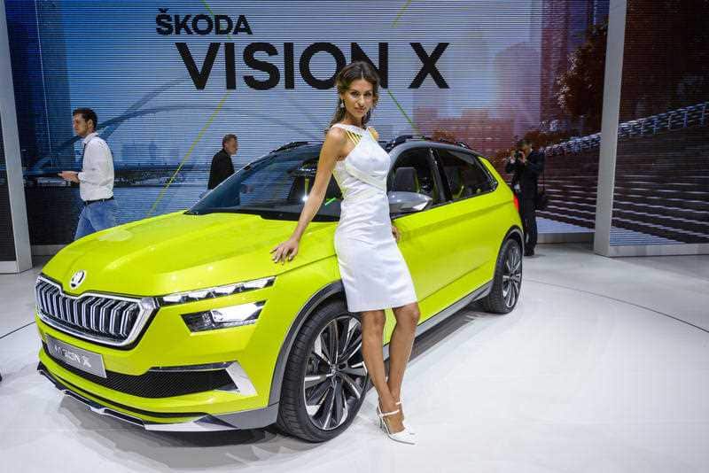 A hostess poses at the 88th Geneva International Motor Show in Geneva. Some automakers want visitors to focus the cars, not the women.