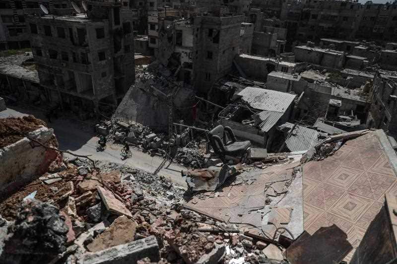 People walk through heavily bombed Douma in eastern Ghouta, Syria.