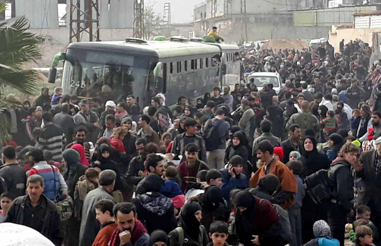 Syrian civilians with their belongings, fleeing from fighting between the Syrian government forces and rebels, in eastern Ghouta