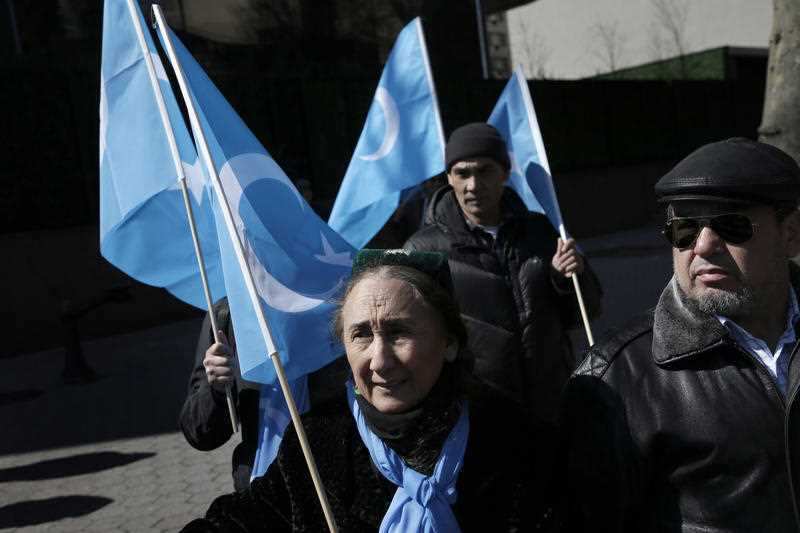 Uighurs and their supporters rally across the street from United Nations headquarters in New York, Thursday, March 15, 2018.