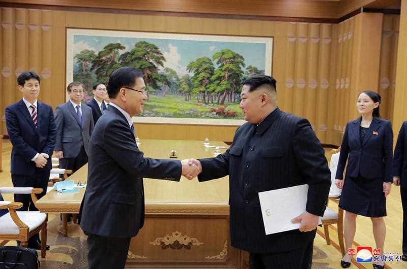 North Korean leader Kim Jong Un, front right, shakes hands with South Korean National Security Director Chung Eui-yong.