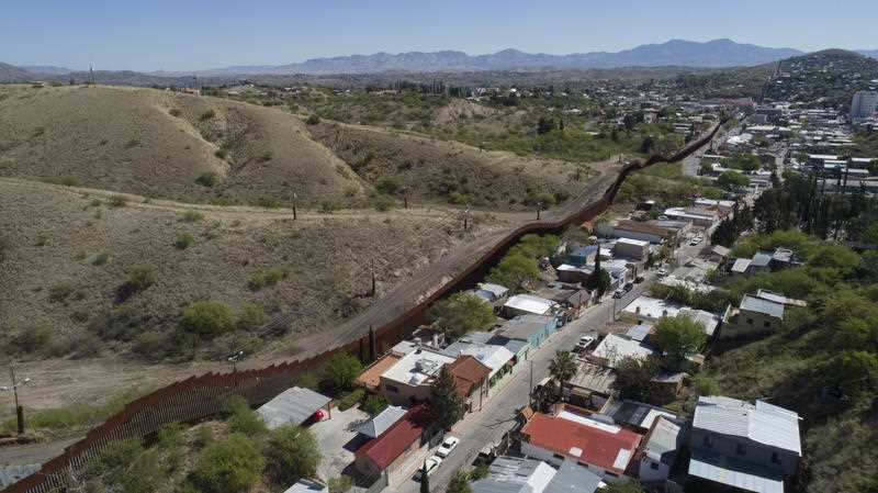 The U.S. Mexico border fence as it cuts through the two downtowns of Nogales, Arizona.