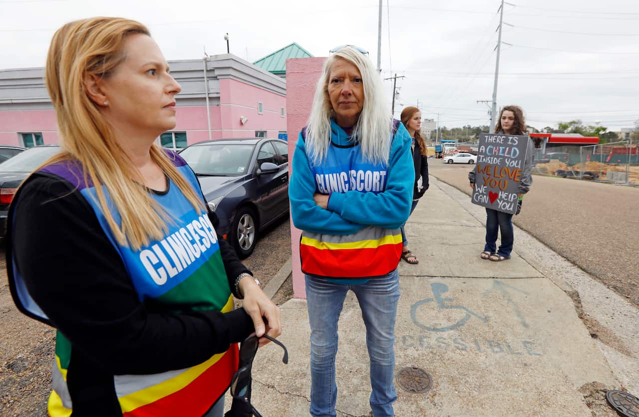 Clinic escorts Kim Gibson, left, and Derenda Hancock stand outside the Jackson Women's Health Organization's clinic in March, 2018.