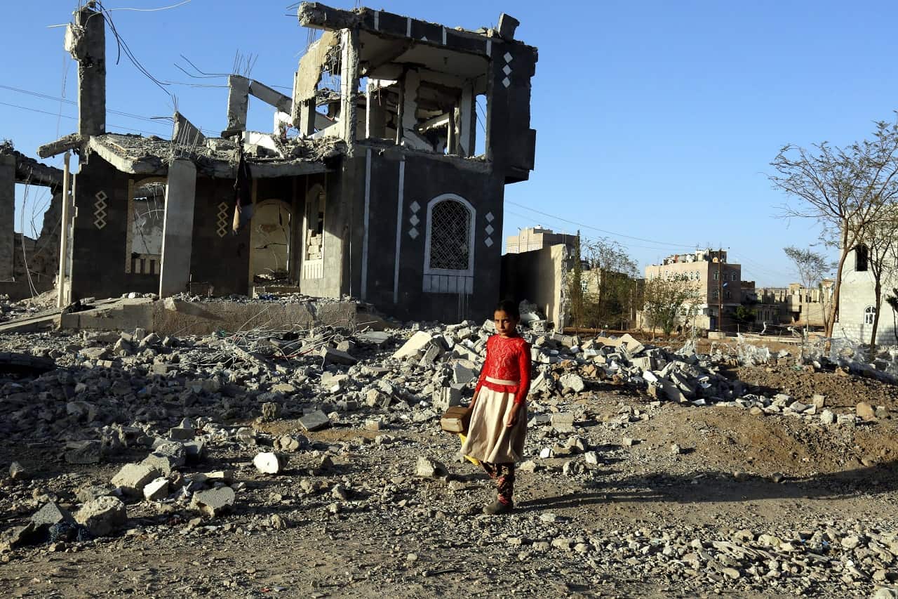 A Yemeni girl walks past a building allegedly destroyed by recent airstrikes, Sana'a, Yemen, 25 March 2018.