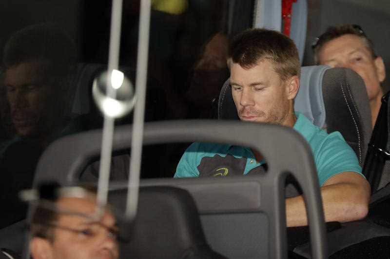 Australia's David Warner, is seated on the team bus after the arrival of the Australian team to OR Tambo International International airport in Johannesburg, South Africa, Tuesday, March 27, 2018.