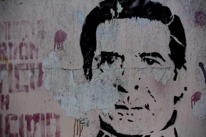 An image of Guatemala's late dictator Efrain Rios Montt covers a wall in downtown Guatemala City, Sunday, April 1, 2018.