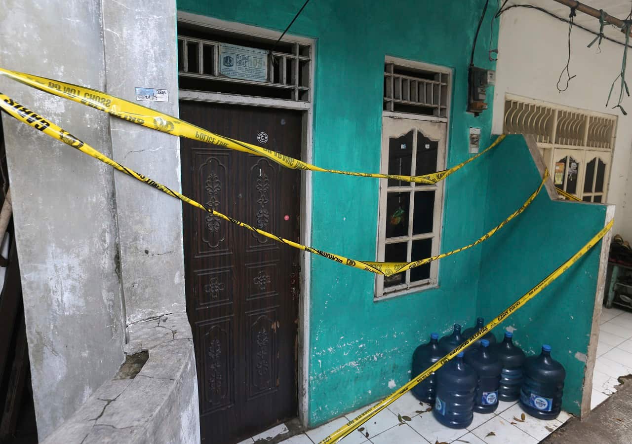Police tape covers a home-based alcohol factory in Jakarta, Indonesia.
