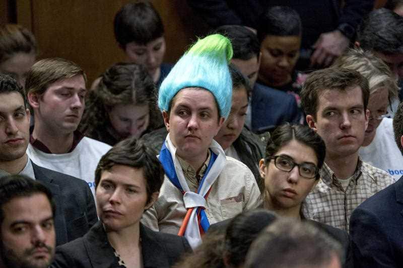 A audience member wearing a blue and green pointy wig, aiming to look like a Russian troll as Facebook CEO Mark Zuckerberg testifies before a joint hearing.