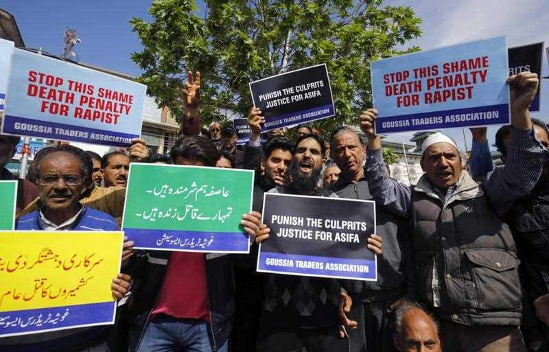 Kashmiri traders hold placards during a protest calling for justice after 8-year-old girl Ashifa Bano was raped and murdered in Srinagar, India, 13 April 2018.