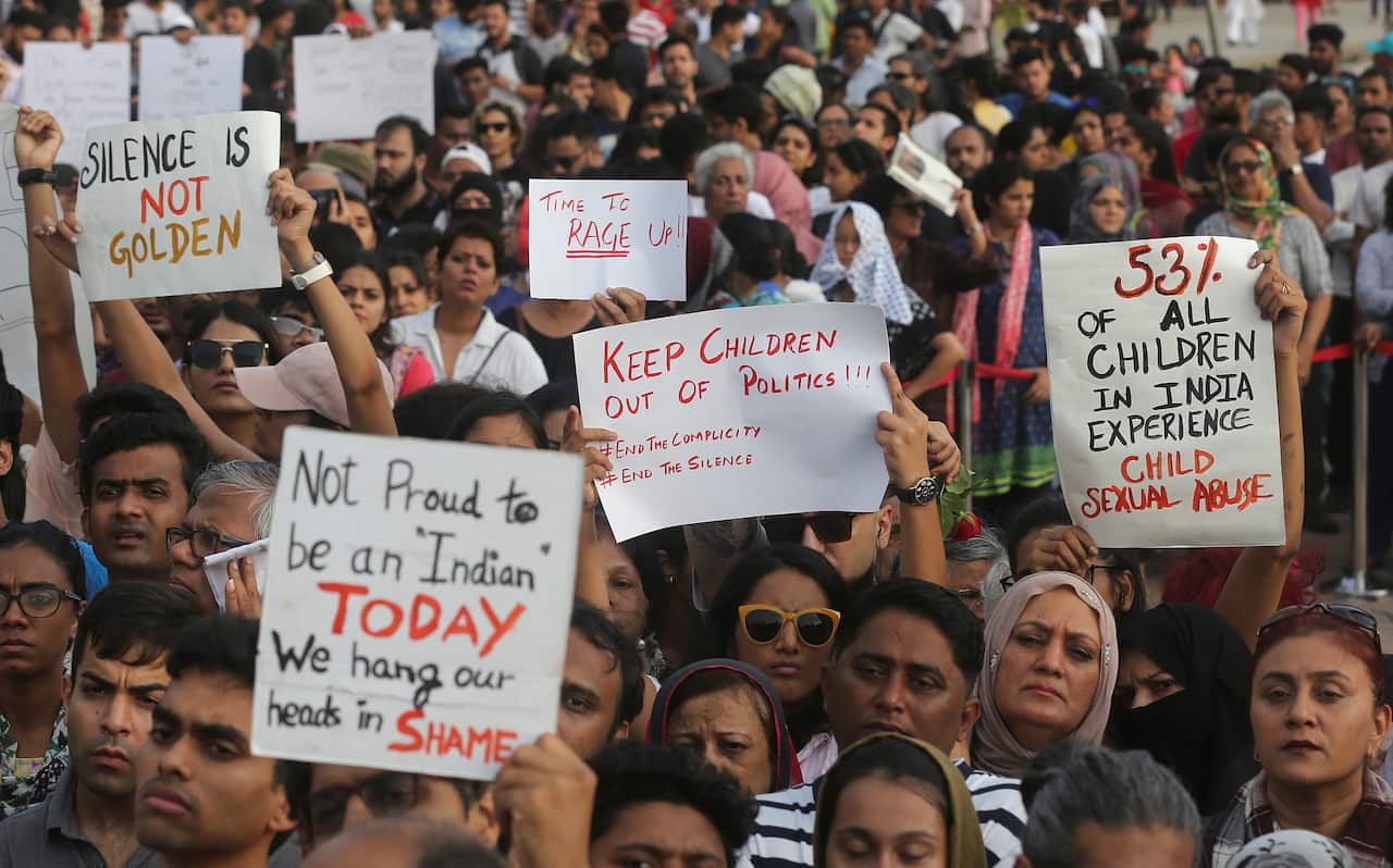 People  holds play card against recent incidents of rape in the country, in Mumbai, India, Sunday, April 15, 2018