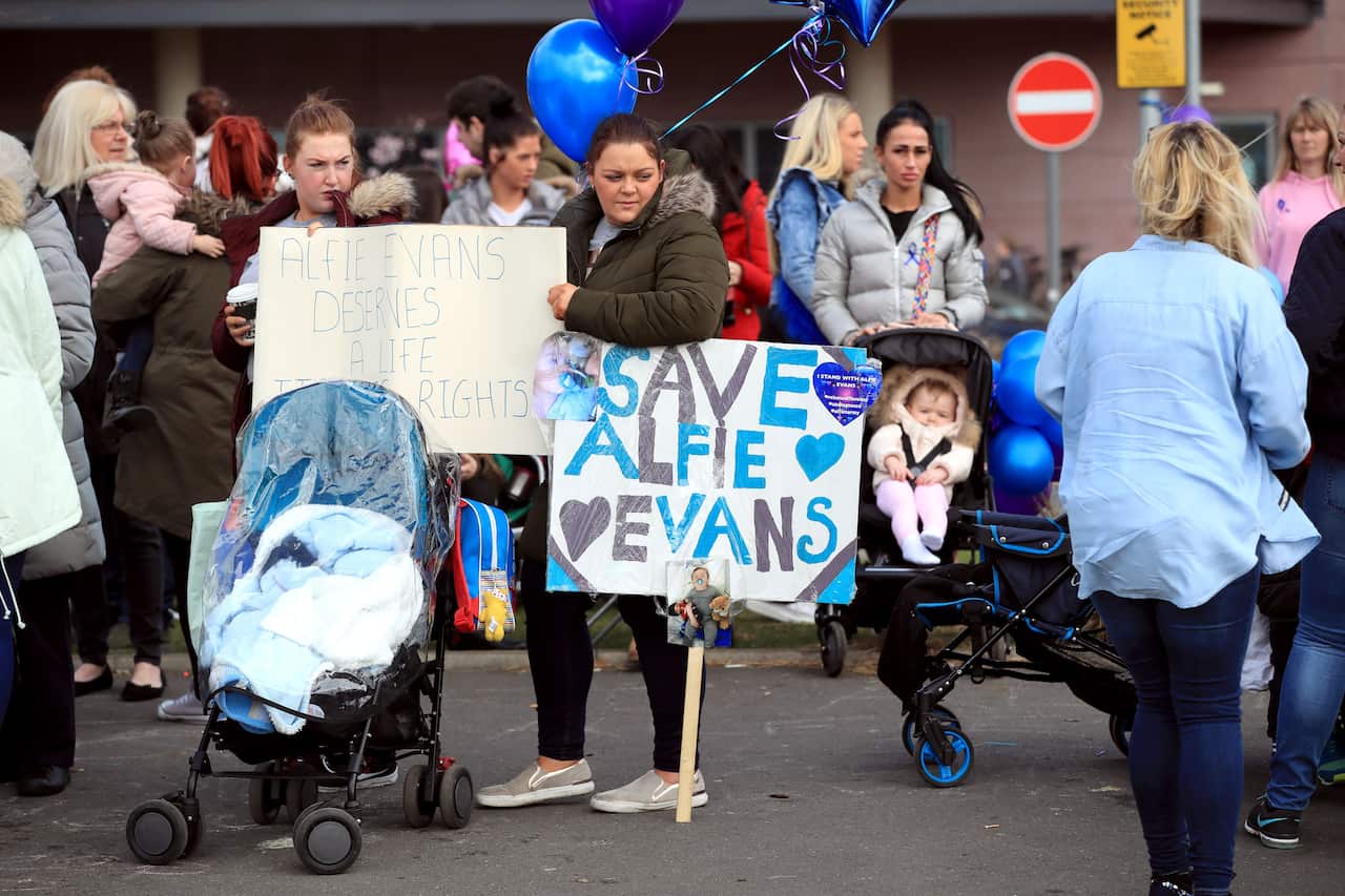 Protestors gather outside Alder Hey Children's Hospital in Liverpool whilst they wait for the latest decision from the Royal Courts of Justice. 
