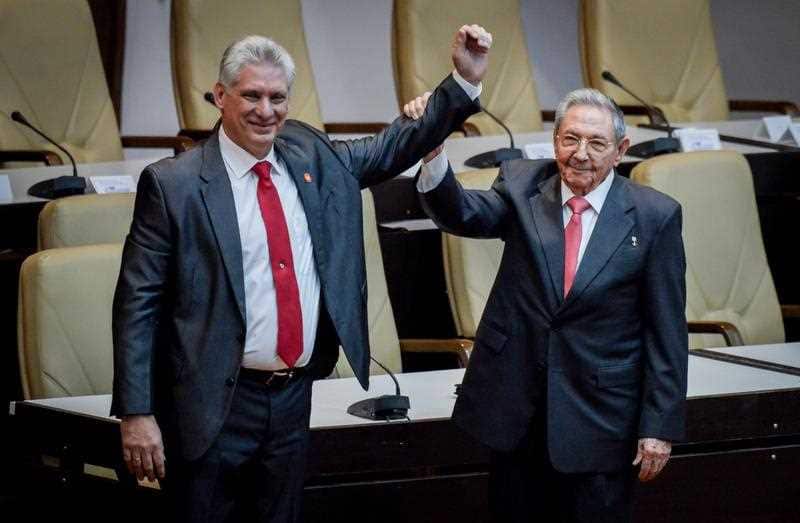  First Secretary of Cuba's Communist Party and now former president Raul Castro (R) holds the arm of new president Miguel Diaz-Canel (L) in Havana, Cuba,