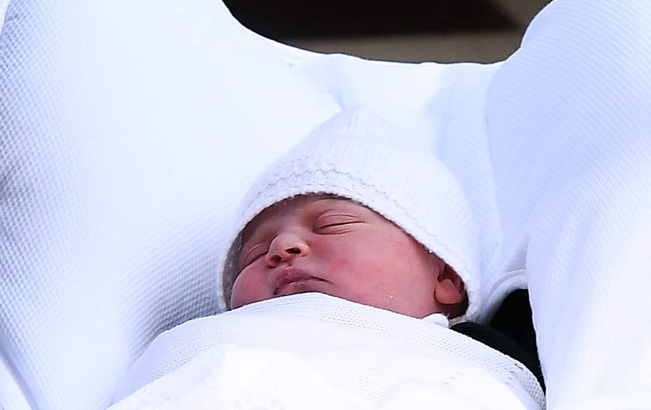 Britain's Prince William, Duke of Cambridge carries his newborn son as they leave the Lindo Wing at St. Mary's Hospital. 
