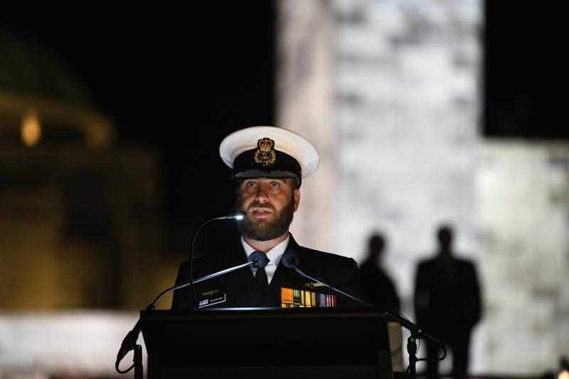 Benjamin Sime reads letters and diaries of Australians who experienced war firsthand during the dawn service at the National War Memorial in Canberra, Wednesday, April 25, 2018.
