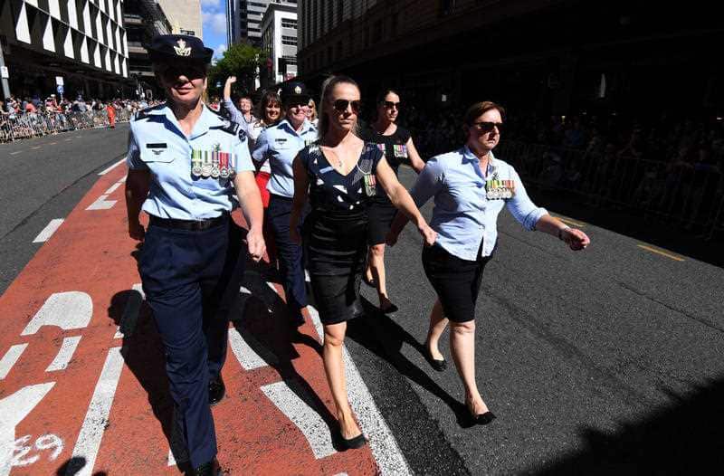 Women are seen marching through Brisbane as part of the By the Left group during Anzac Day commemorations in Brisbane, Wednesday, April 25, 2018.