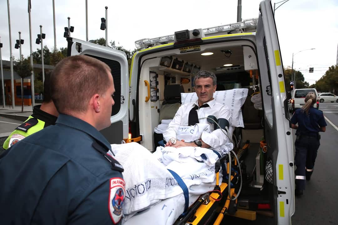 Dover owner Terry McMaster leaves the Federal Court with the aid of paramedics after collapsing at the banking royal commission. 