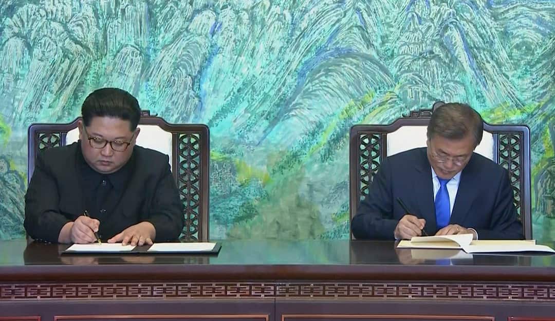 North Korean leader Kim Jong-un and South Korean President Moon Jae-in sign a joint statement at the border village of Panmunjom in the Demilitarised Zone.
