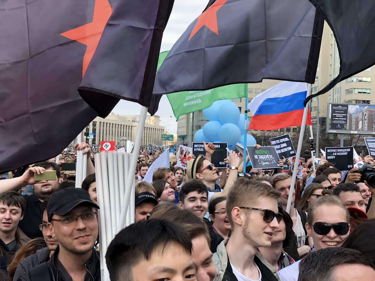 Protesters wave flags during an opposition rally in central Moscow on April 30, 2018.