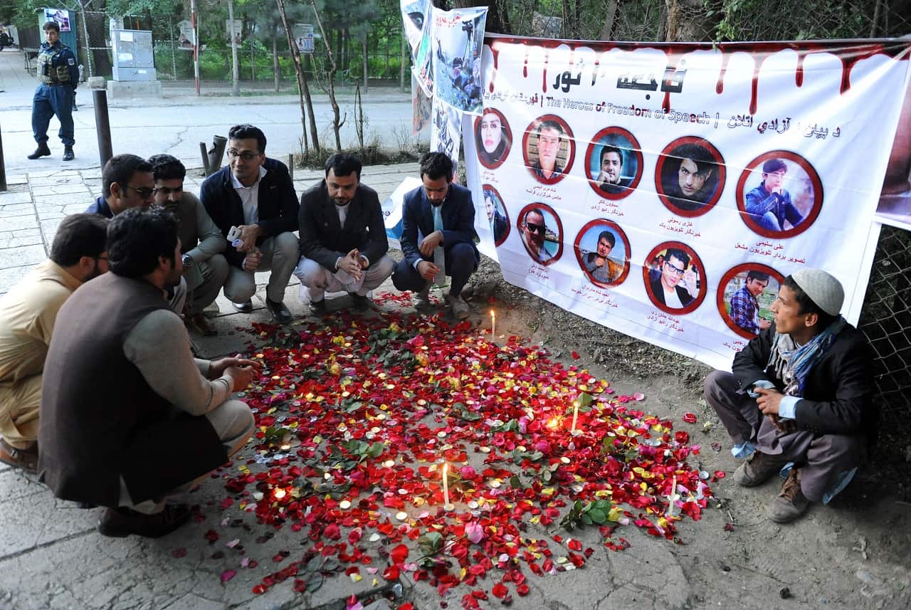 Afghan journalists light candles at the place where 24 people including 9 journalists were killed in Kabul, Afghanistan 03 May 2018. 