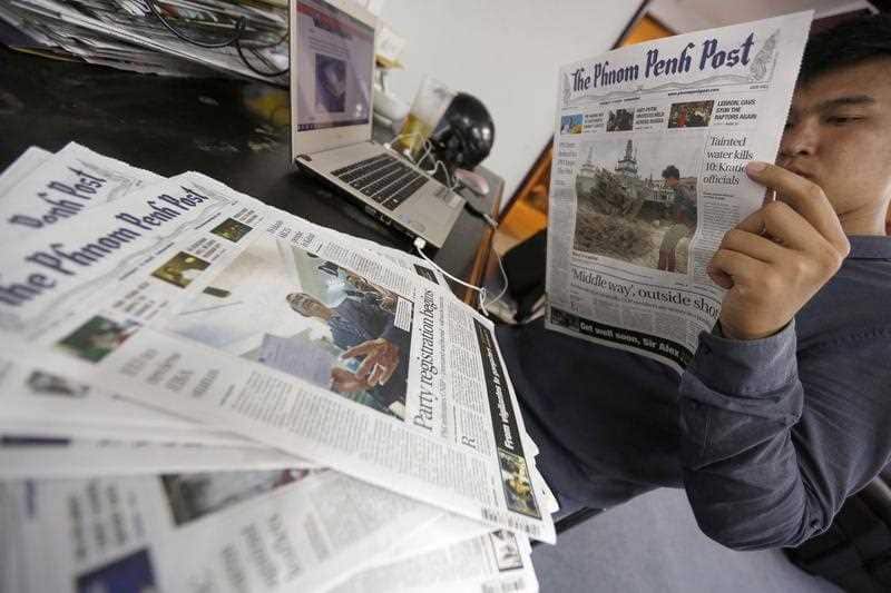A person reads an issue of The Phnom Penh Post newspaper at an office in Phnom Penh, Cambodia, 07 May 2018.