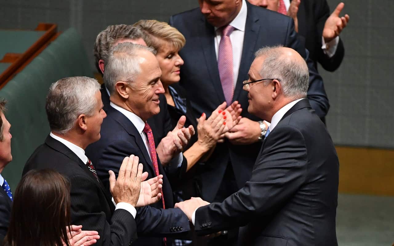 Prime Minister Malcolm Turnbull shakes hands with Treasurer Scott Morrison after delivering the 2018 Budget in the House of Representatives at Parliament House in Canberra, Tuesday, May 8, 2018. (AAP Image/Mick Tsikas) NO ARCHIVING