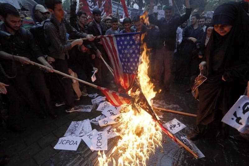 Iranians burn US and Israeli flags during an anti-US protest in front of the former US embassy in Tehran, Iran, 09 May 2018. 