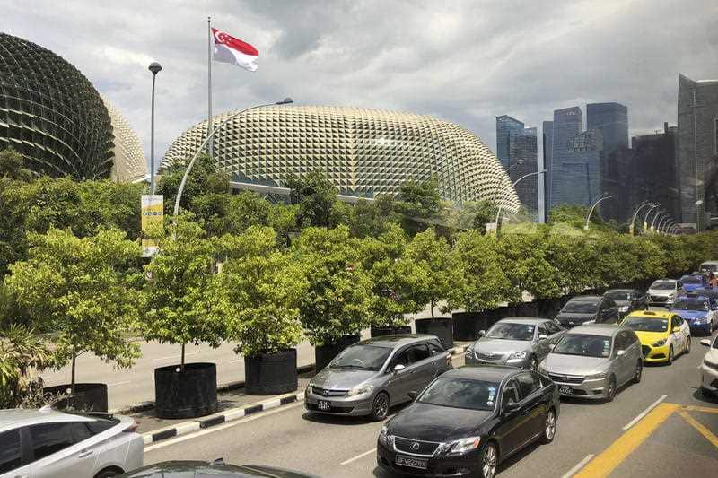 The national flag of Singapore flies against the financial skyline lining the edge of the Singapore River on Thursday, May 10, 2018, in Singapore.