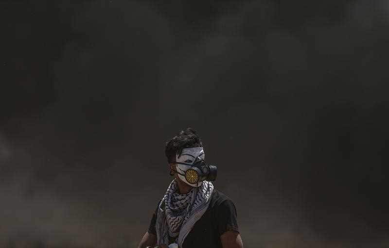 A Palestinian protester during clashes after protests near the border with Israel in the east of Jabaliya in the northern Gaza Strip, 14 May 2018.