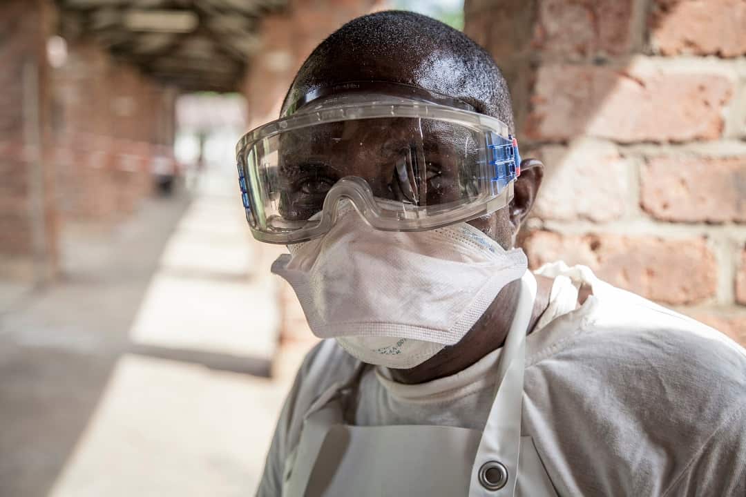 A health worker outside an isolation ward to diagnose and treat suspected Ebola patients.
