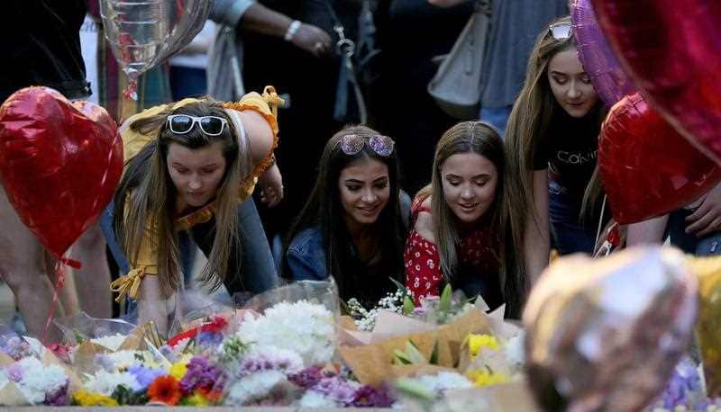 People pay their respects in St Annes Square on the 1st anniversary of the Manchester Arena bombing in Manchester, Britain, 22 May 2018.