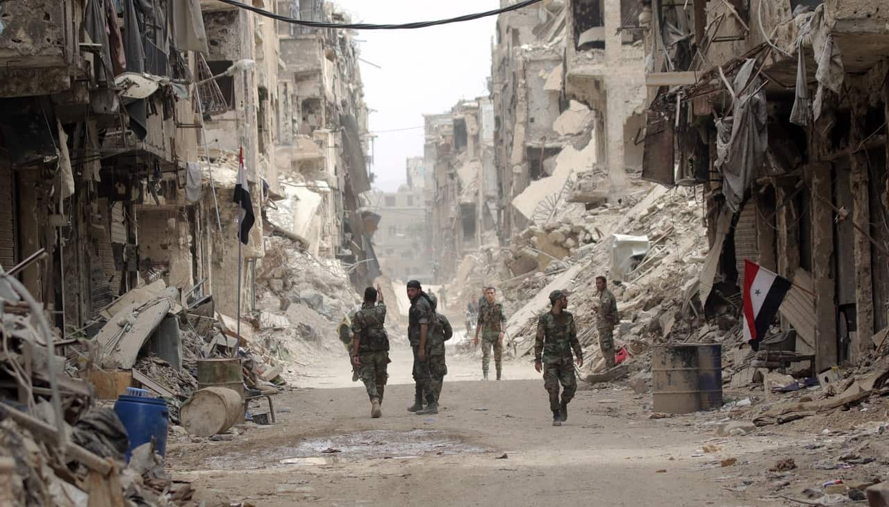 Syrian soldiers patrol at the Yarmouk Camp district in south Damascus in 2018.