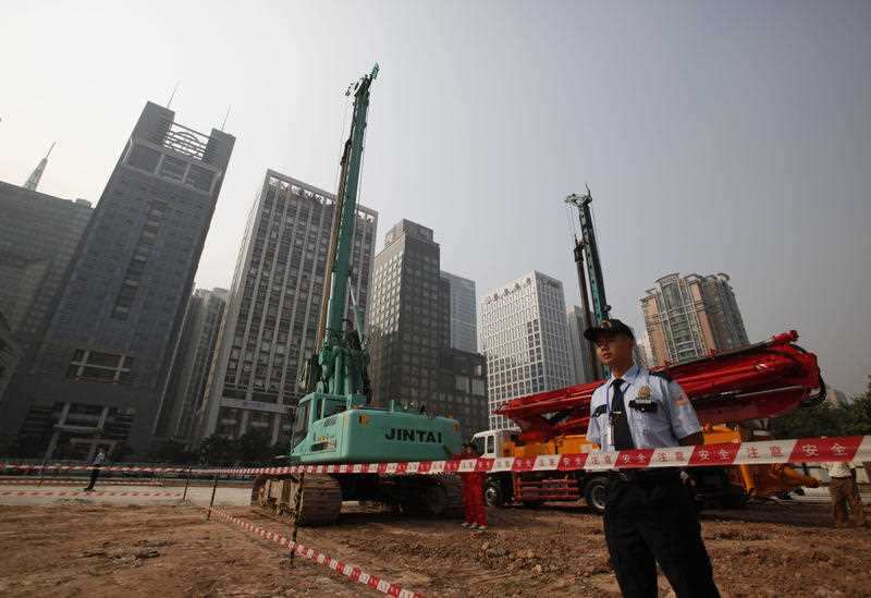 FILE - In this Oct. 26, 2009 file photo, security workers guard at construction site of the U.S. Consulate compound in Guangzhou in southern China's Guangdong province.