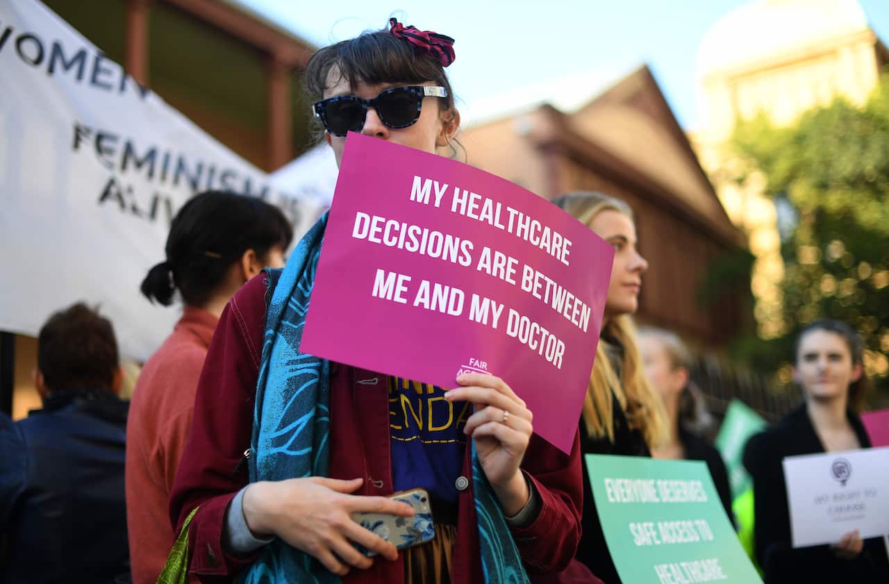 Demonstrators in favour of safe buffer-zones around NSW abortion clinics stand outside the NSW State Parliament building in Sydney, Thursday, May 24, 2018.