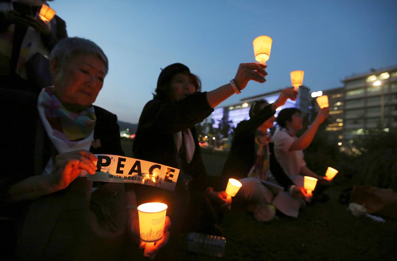 Protesters hold candle lights during a rally to denounce the United States' policies against North Korea near the US embassy in Seoul.