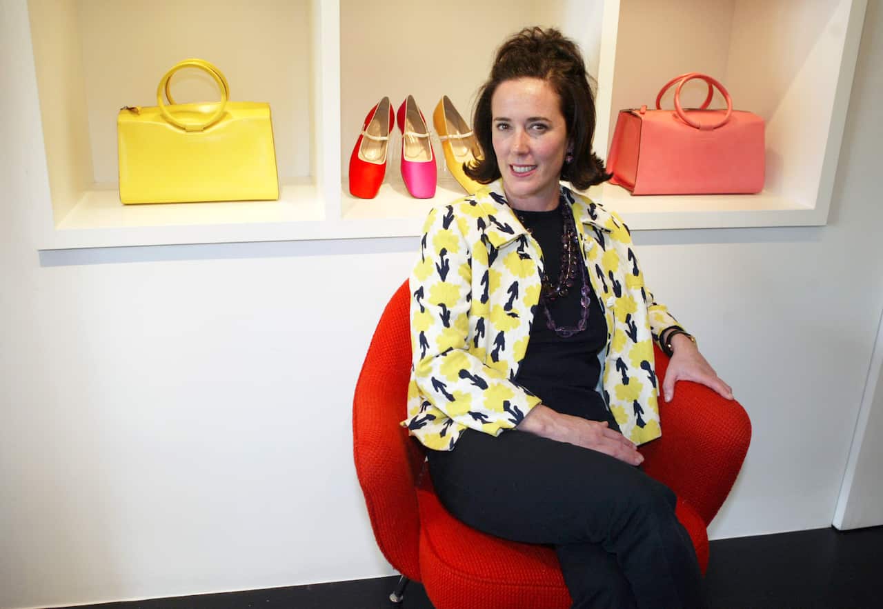 This May 13, 2004 photo shows designer Kate Spade posing among handbags and shoes from her collection in New York. (AP Photo/Bebeto Matthews, File)