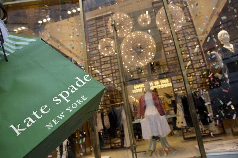 A woman carries her Kate Spade shopping bag outside the fashion designer's Madison Avenue store