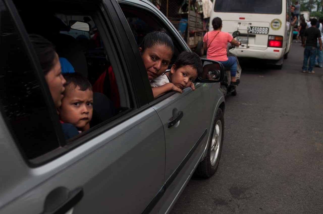 Residents evacuate after a new flow of lava moved down the slopes of the Fuego Volcano in Guatemala.