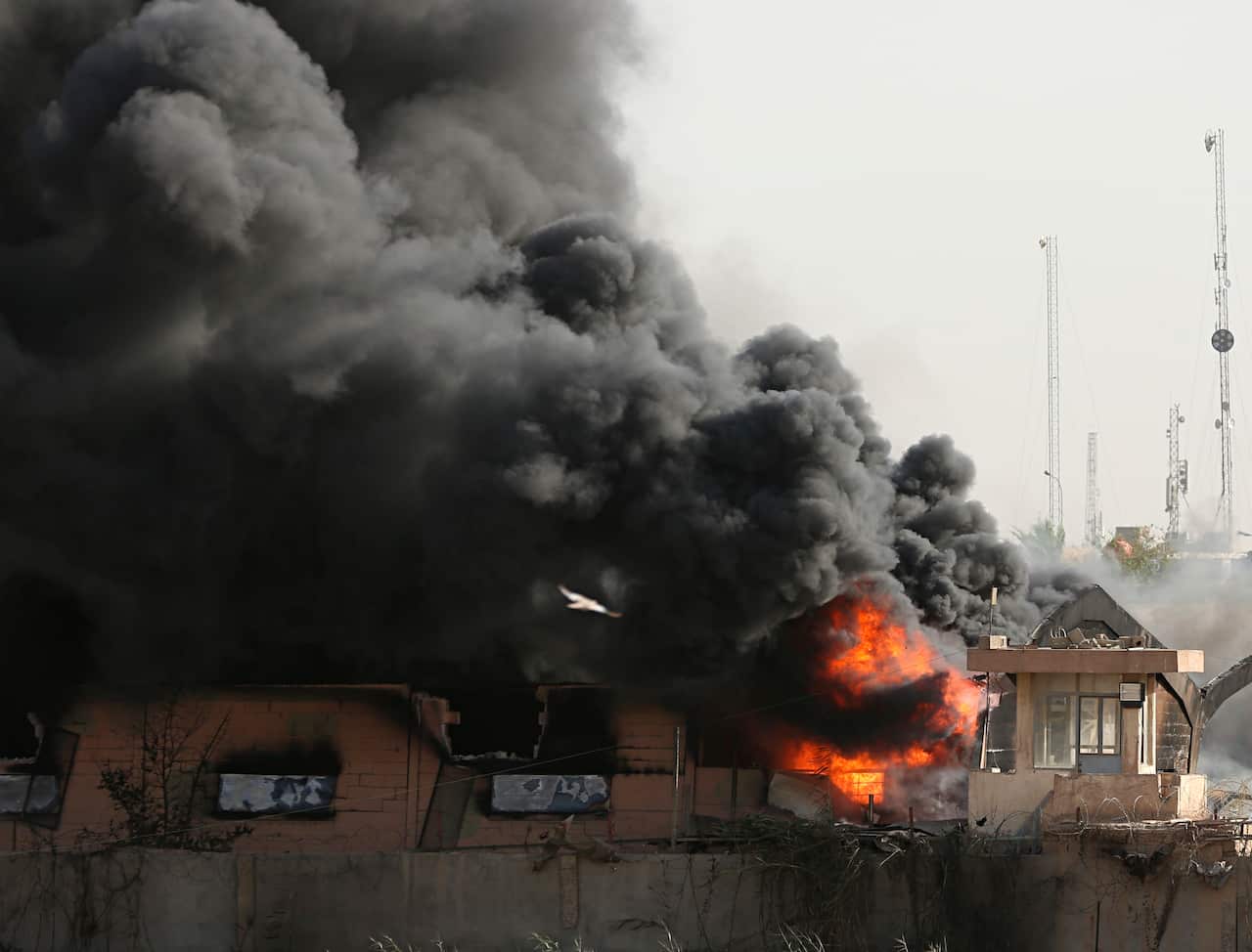 Plumes of smoke rise after a fire broke out at Baghdad's largest ballot box storage site