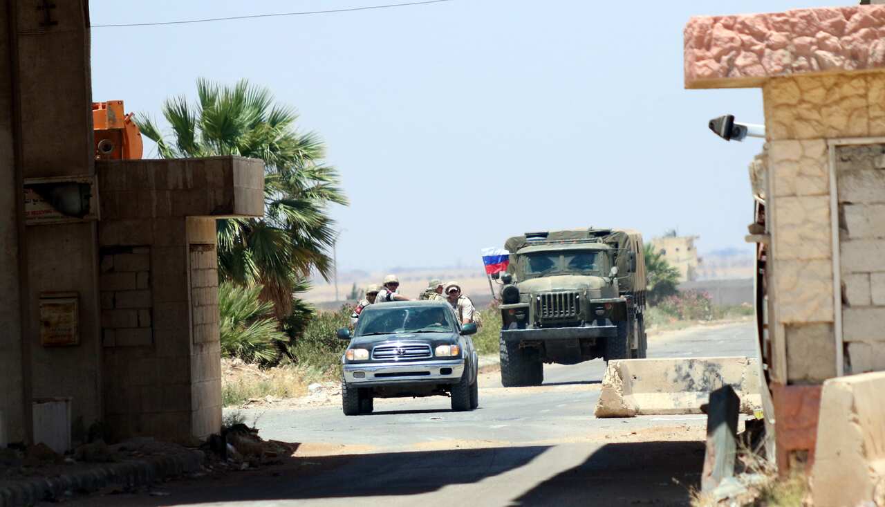 Russian soldiers drive at Nassib border crossing in the southeastern countryside of Daraa. 