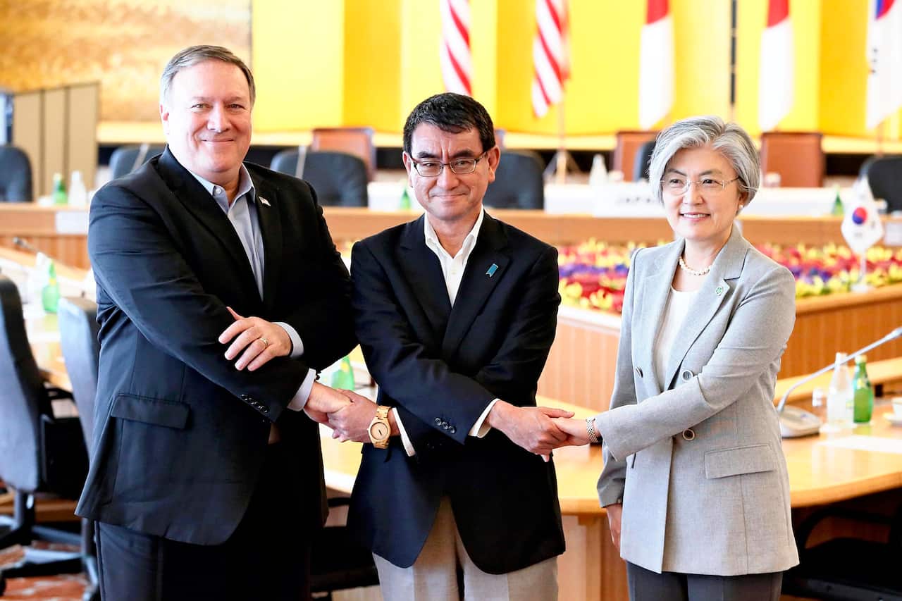 (L to R) U.S. Secretary of State Mike Pompeo, Japan's Foreign Minister Taro Kono and South Korea's Foreign Minsiter Kang Kyung-wha shake hands prior to their meeting at Iikura Guest House in Tokyo on July 8, 2018.( The Yomiuri Shimbun via AP Images )