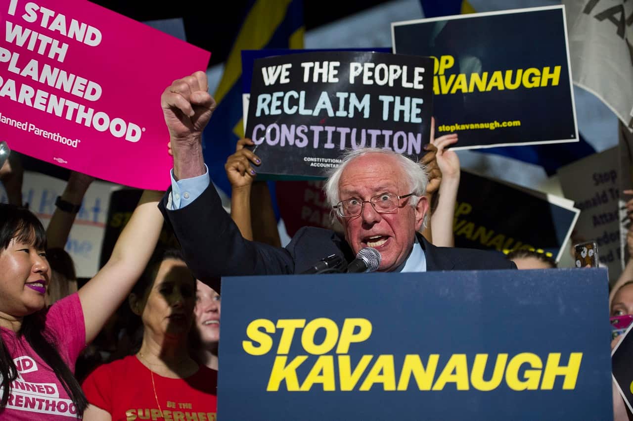 Bernie Sanders speaks with protesters in front of the Supreme Court .